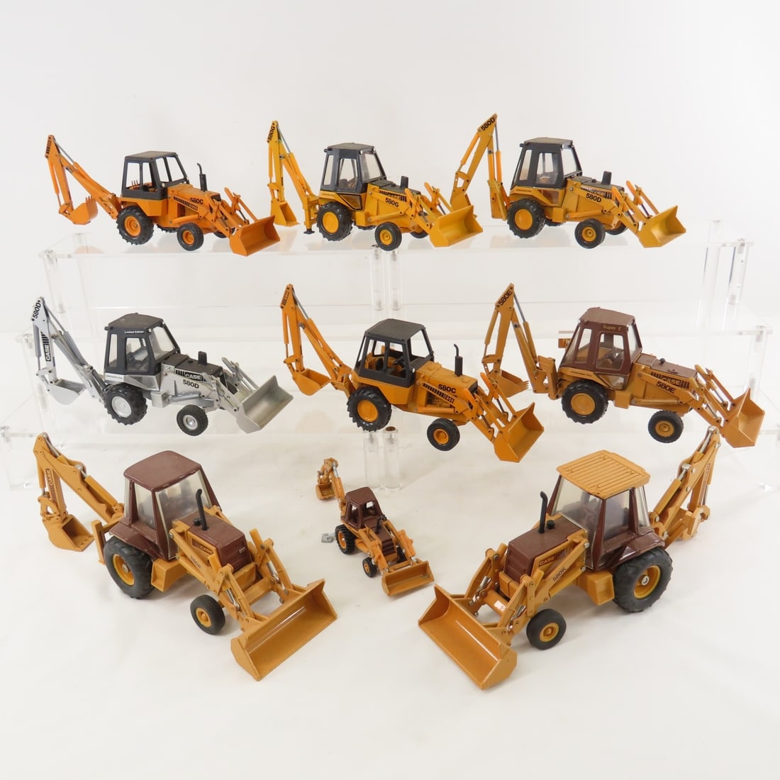 3 ERTL & 6 Conrad Case 580 Backhoe Loaders: 3 ERTL & 6 Conrad Case 580 Backhoe Loaders - Conrad is W. Germany, approx 1/35 diecast- 1 is smaller. several 580 variations. LOT SIZE: 14x14x4" 7 LBS All information and photos, which are part of