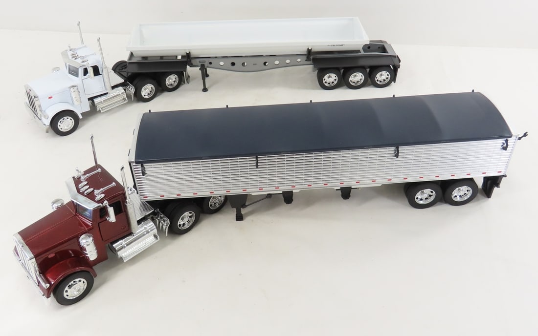 2 New Ray Peterbilt Tractors & Trailers: 2 New Ray Peterbilt Tractors & Trailers - 1 side dump and 1 grain trailer. Approx: 1/34 scale, all plastic, LOT SIZE: 17x13x5" 4 LBS All information and photos, which are part of the description, are
