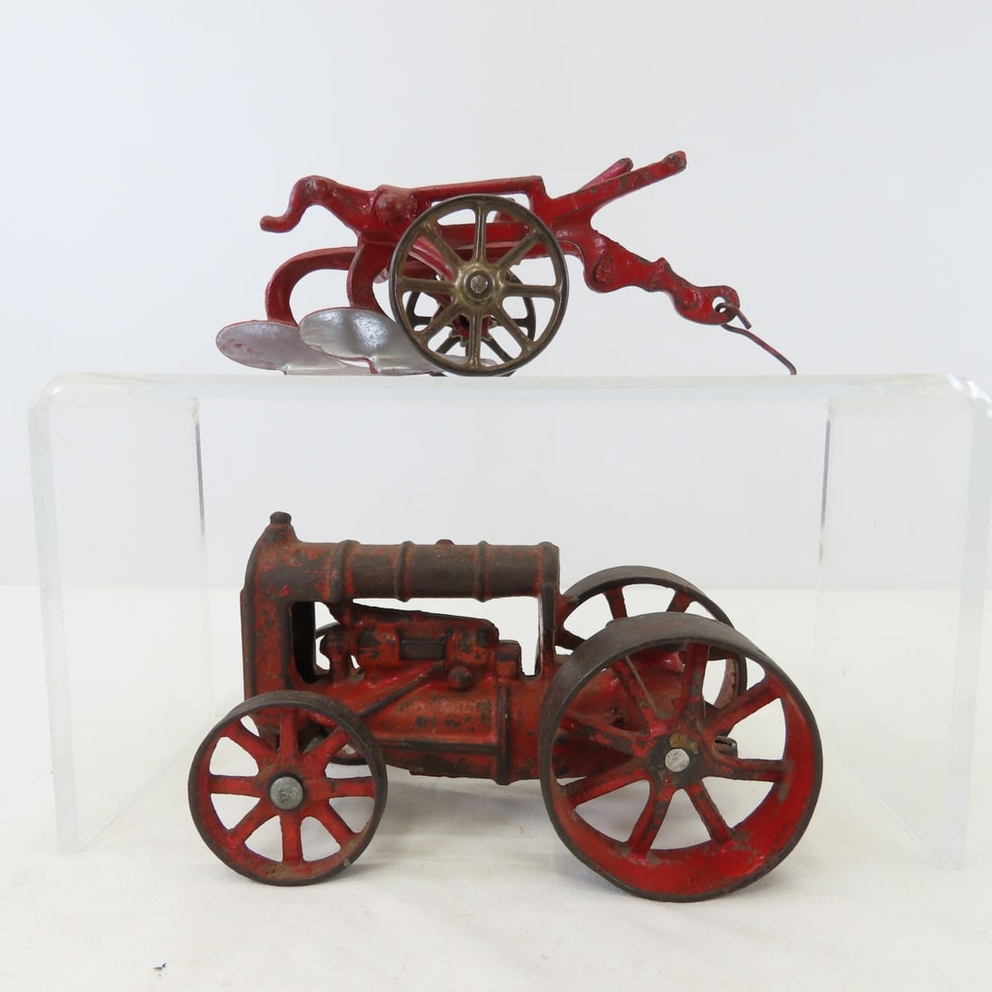Cast Iron Fordson Tractor & 2 Bottom Plow: Cast Iron Fordson Tractor & 2 Bottom Plow - unmarked, LOT SIZE: 8x6x4" 3 LBS All information and photos, which are part of the description, are intended to be as accurate as possible, but errors are