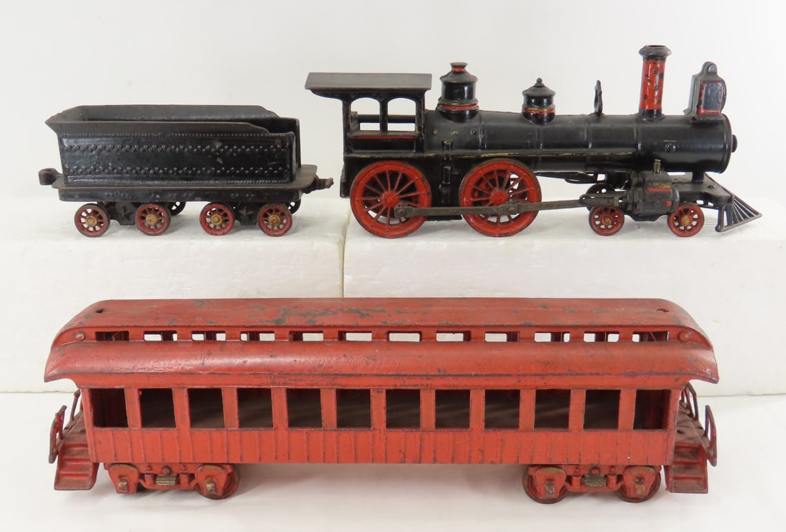 Wilkins Cast Iron Train Engine, Tender & Car: Wilkins Cast Iron Train Engine, Tender & Car - engine(missing part of rear canopy), Coal Car, 15" Passenger Car. LOT SIZE: 16x9x6" 14 LBS All information and photos, which are part of the