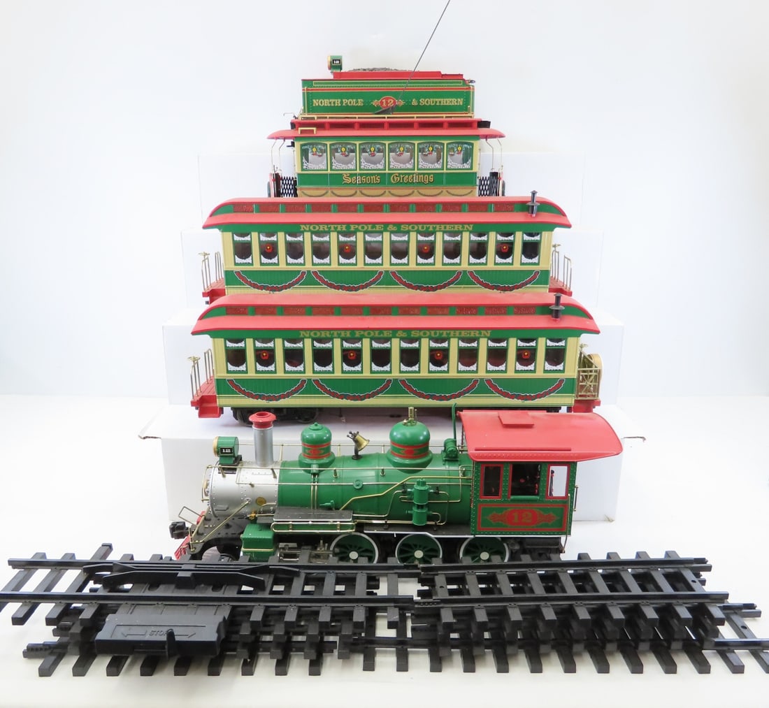 Bachmann #12 North Pole & Southern G Scale Train: Bachmann #12 North Pole & Southern G Scale Train - 4-6-0 Engine, coal tender & 2 passenger cars with track, all plastic. Also Bachmann Season's Greetings Christmas Street Car. LOT SIZE: 20x16x18" 20