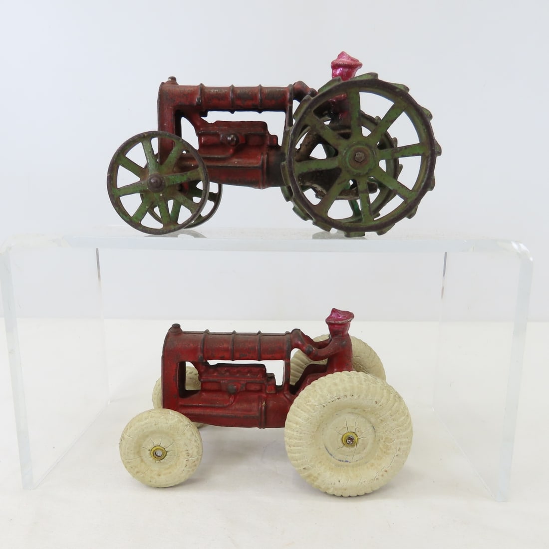 2 Repaired Arcade Cast Iron Tractors: 2 Repaired Arcade Cast Iron Tractors - both heads have been repaired, 1 with steel wheels and 1 rubber wheels. LOT SIZE: 6x7x4" 2 LBS All information and photos, which are part of the description,