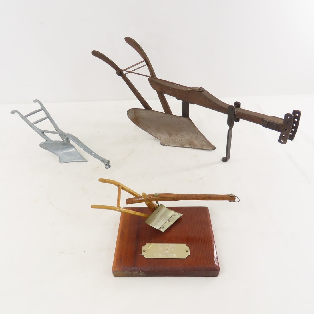 3 J Deere 1837 First Plow Models,1 by Herb Bothe: 3 J Deere 1837 First Plow Models,1 by Herb Bothe - Herb Bothe's is on display 8x4.5x3.5", largest metal & wood is 16", all metal cast marked MACK is 9.5". LOT SIZE: 16x7x8" 3 LBS All information and