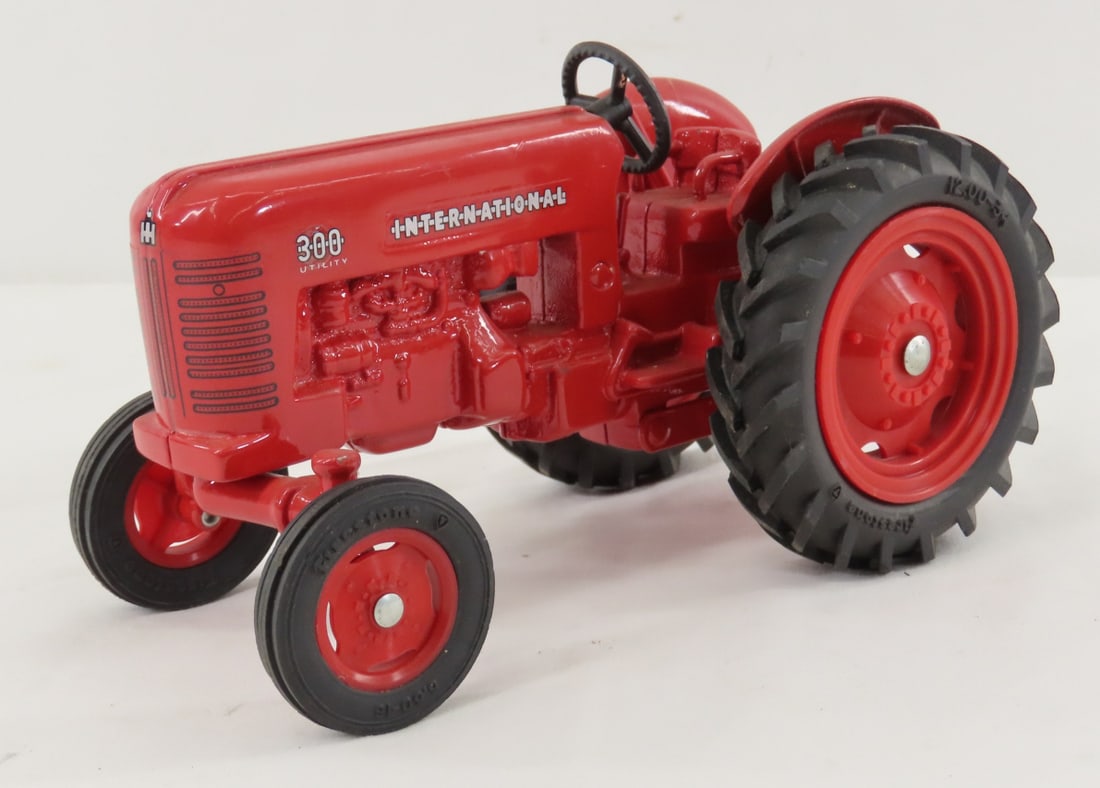 Unmarked Custom International 300 Utility Tractor: Unmarked Custom International 300 Utility Tractor - 1/16 diecast, Firestone tires LOT SIZE: 8x5x4" 2 LBS All information and photos, which are part of the description, are intended to be as accurate
