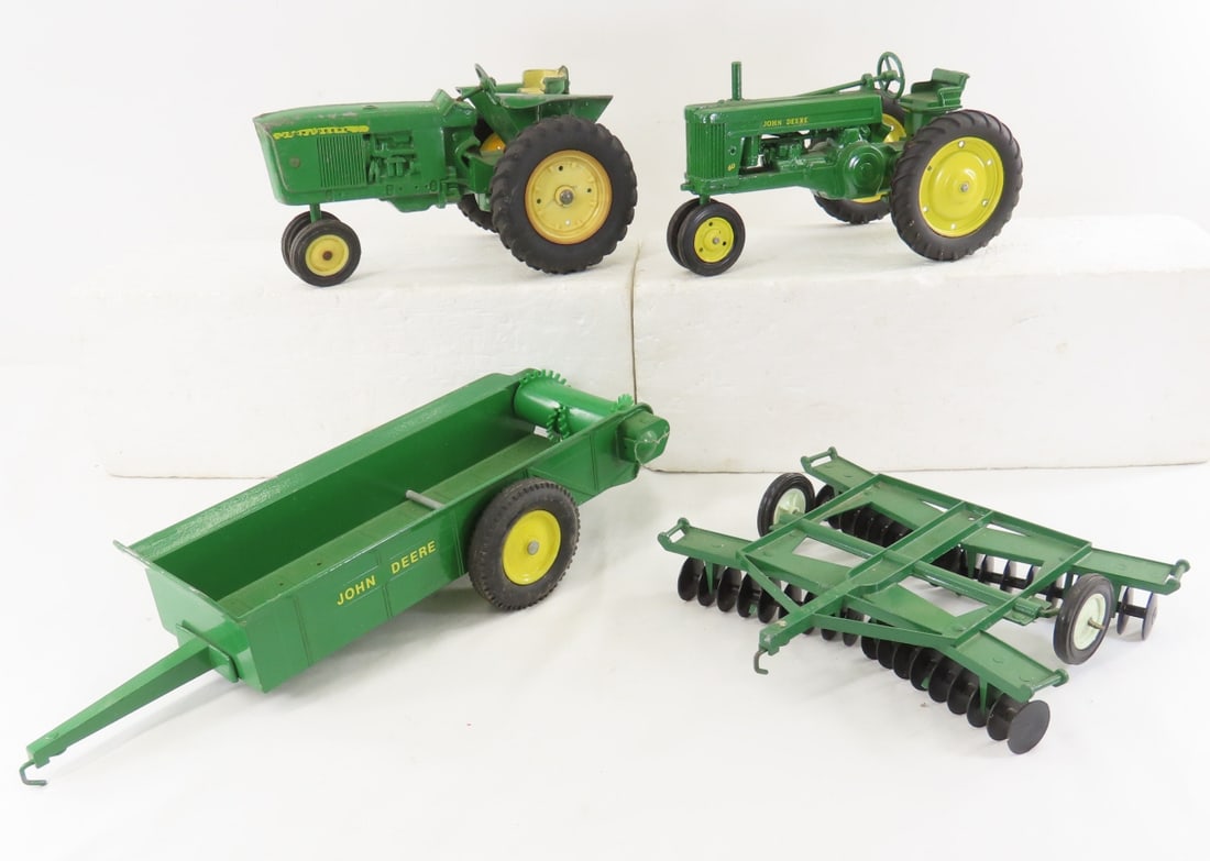2 John Deere Tractors, Spreader & Disc Harrow: 2 John Deere Tractors, Spreader & Disc Harrow - early John Deere NF with broken hitch, John Deere 60 made in USA, ERTL manure spreader, ERTL disc harrow, 1/16 diecast, LOT SIZE: 17x11x5" 6 LBS All