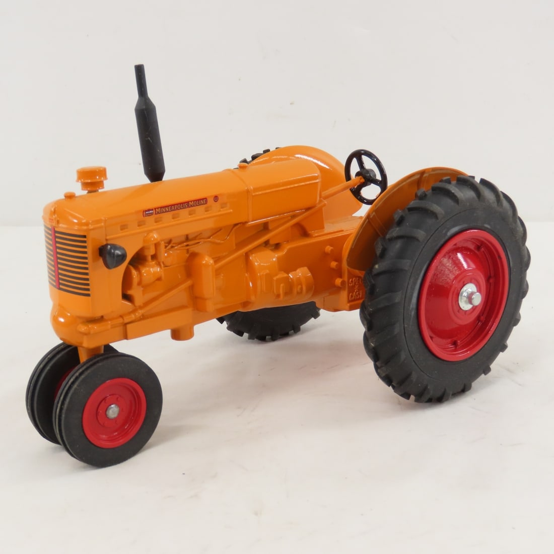Spec Cast Minneapolis-Moline NF Tractor: Spec Cast Minneapolis-Moline NF Tractor - 1/16 diecast, LOT SIZE: 9x5x4" 2 LBS All information and photos, which are part of the description, are intended to be as accurate as possible, but errors