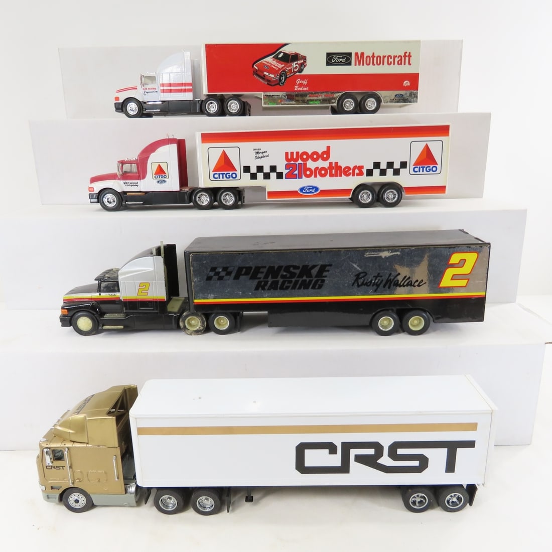 3 Racing Champions & 1 Unmarked Tractor Trailer: 3 Racing Champions & 1 Unmarked Tractor Trailer - Racing Champions 1992 Ford Motorcraft, CITGO 21 Wood Brothers, & Rusty Wallace 2 Penske. 1 slightly smaller unmarked CRST truck, 11" trailers,