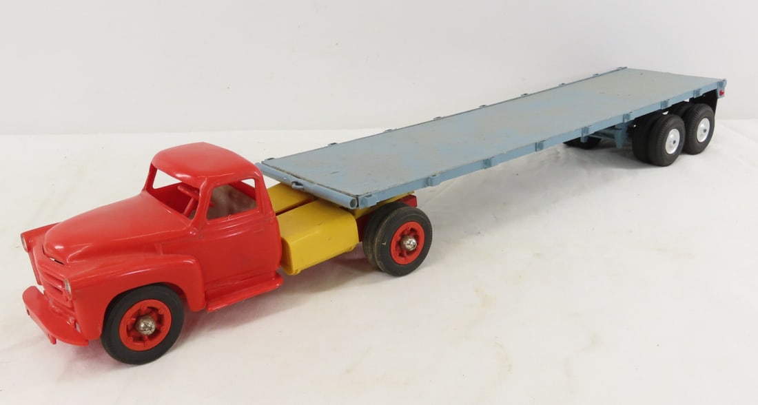 Custom Wood Flat Bed Trailer with Plastic Truck: Custom Wood Flat Bed Trailer with Plastic Truck - unmarked, trailer is 16" wood and plastic. LOT SIZE: 17x9x4" 2 LBS All information and photos, which are part of the description, are intended to be