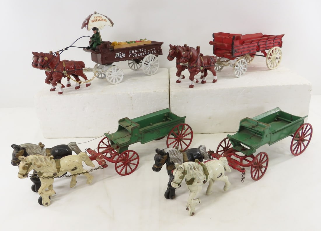 2 Kenton & 2 Repro Cast Iron Horse Drawn Wagons: 2 Kenton & 2 Repro Cast Iron Horse Drawn Wagons - 1 Kenton horse is missing wheel, LOT SIZE: 19x16x5" 19 LBS All information and photos, which are part of the description, are intended to be as