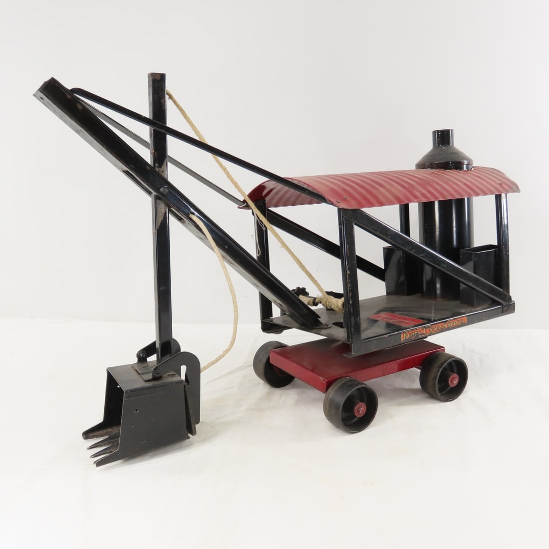 1920s Buddy L Pressed Steel Steam Shovel: 1920s Buddy L Pressed Steel Steam Shovel - original stickers- replaced rope, LOT SIZE: 22x15x10" 8 LBS All information and photos, which are part of the description, are intended to be as accurate as
