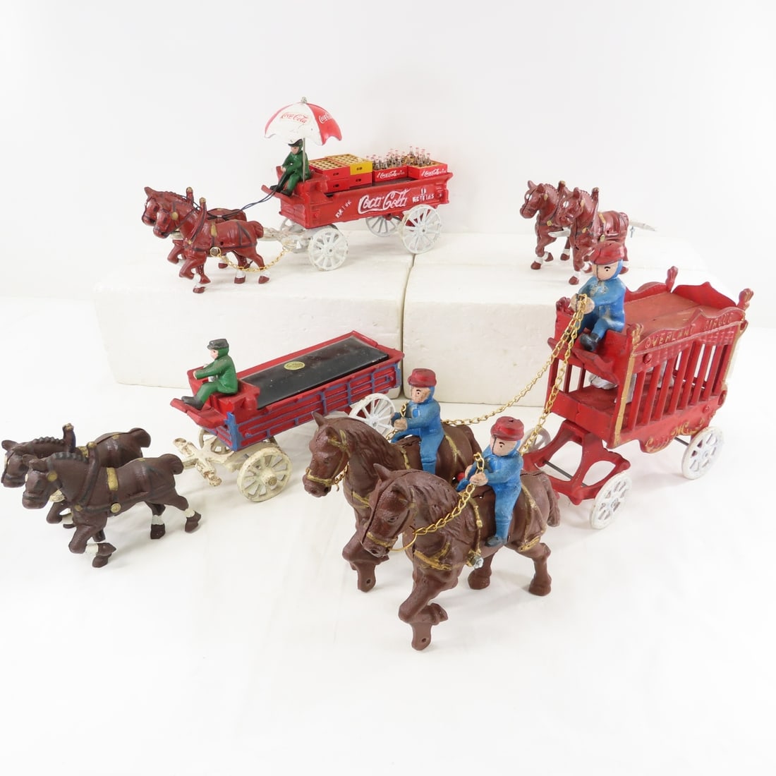 3 Reproduction Cast Iron Horse Drawn Wagons: 3 Reproduction Cast Iron Horse Drawn Wagons - 1 Coca-Cola, 1 Overland Circus with Polar Bear in Wagon, other incomplete beer wagon. LOT SIZE: 17x15x8" 24 LBS All information and photos, which are