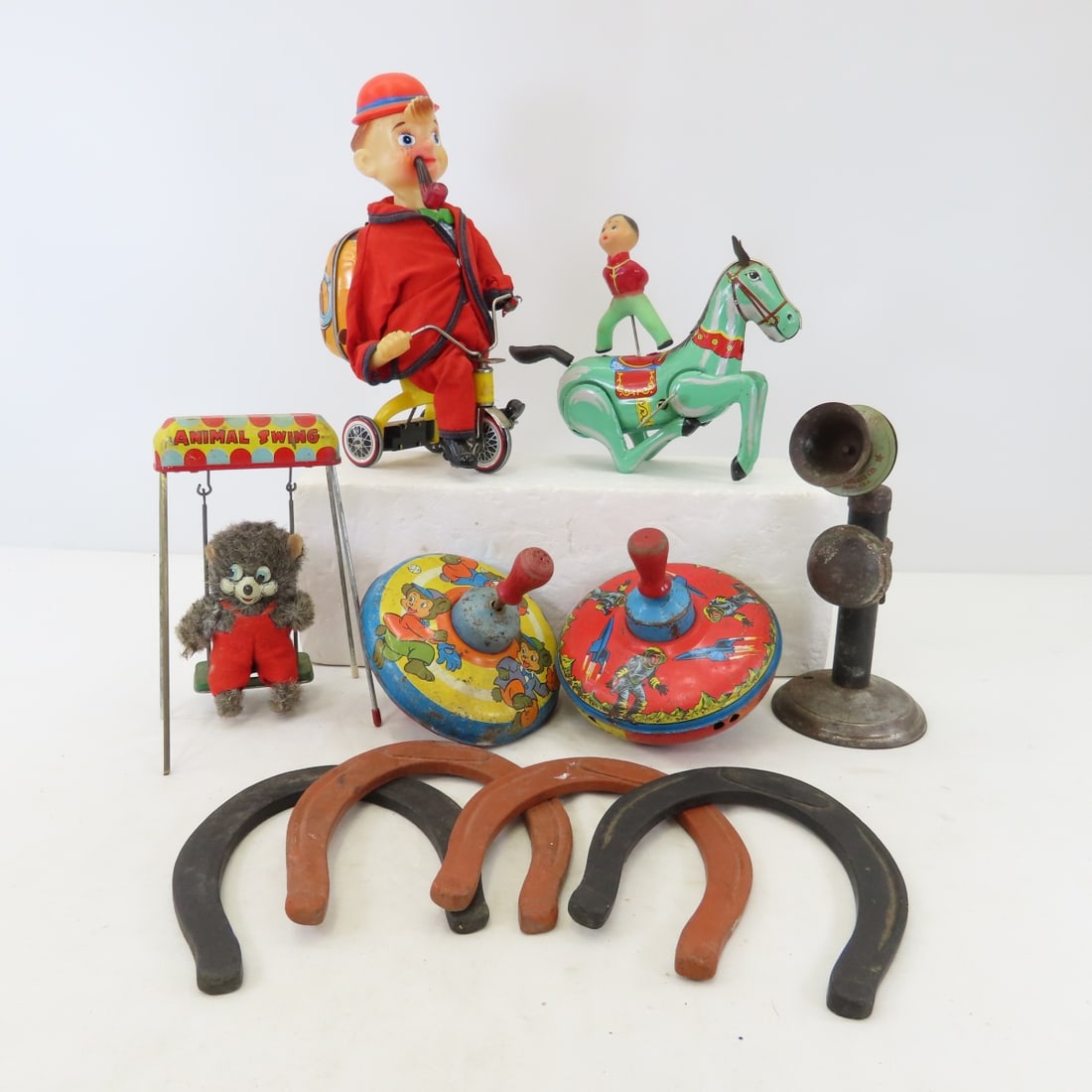 Tin Litho Key Wind, and Other Toys: Tin Litho Key Wind, and Other Toys - key wind horse with rider- made in China- works, Cycling Daddy- batt. op.- not working- Bandai Japan, wind up animal swing- works, Kidde Bell phone toy, Ohio art t
