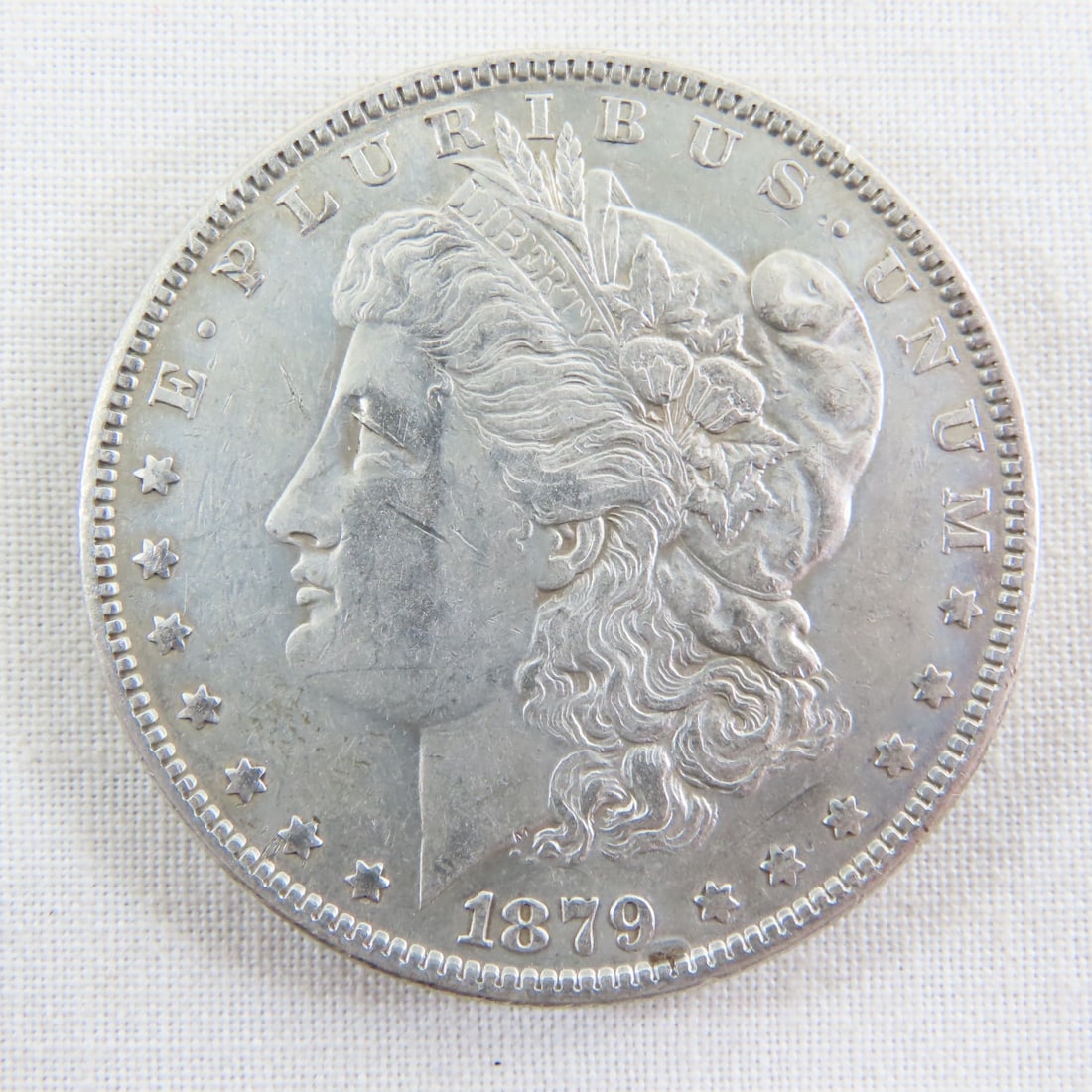 1879 Morgan Silver Dollar: 1879 Morgan Silver Dollar - Lot Size 2x2x1" 1 LB All information and photos are intended to be as accurate as possible, but errors are possible. No item may be returned or refused based on this
