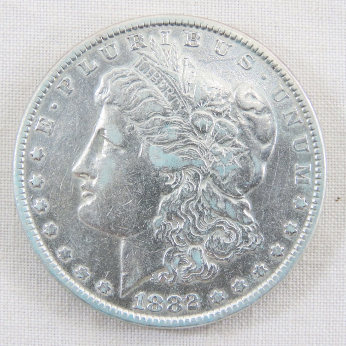 1882 Morgan Silver Dollar: 1882 Morgan Silver Dollar - Lot Size 2x2x1" 1 LB All information and photos are intended to be as accurate as possible, but errors are possible. No item may be returned or refused based on this