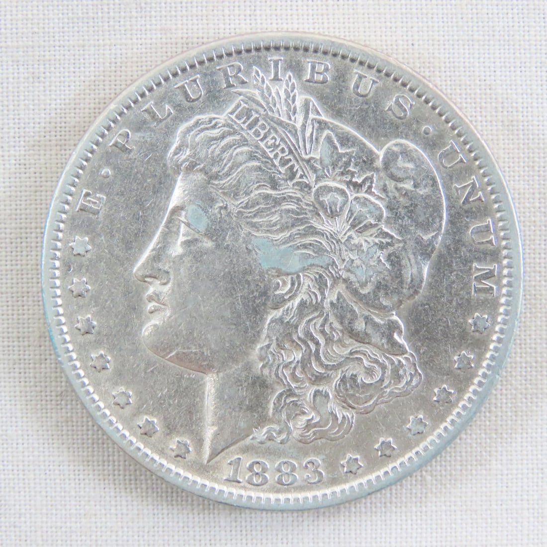 1883 Morgan Silver Dollar: 1883 Morgan Silver Dollar - Lot Size 2x2x1" 1 LB All information and photos are intended to be as accurate as possible, but errors are possible. No item may be returned or refused based on this