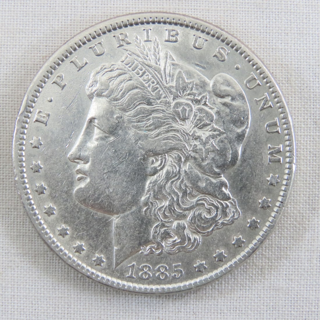 1885 Morgan Silver Dollar: 1885 Morgan Silver Dollar - Lot Size 2x2x1" 1 LB All information and photos are intended to be as accurate as possible, but errors are possible. No item may be returned or refused based on this