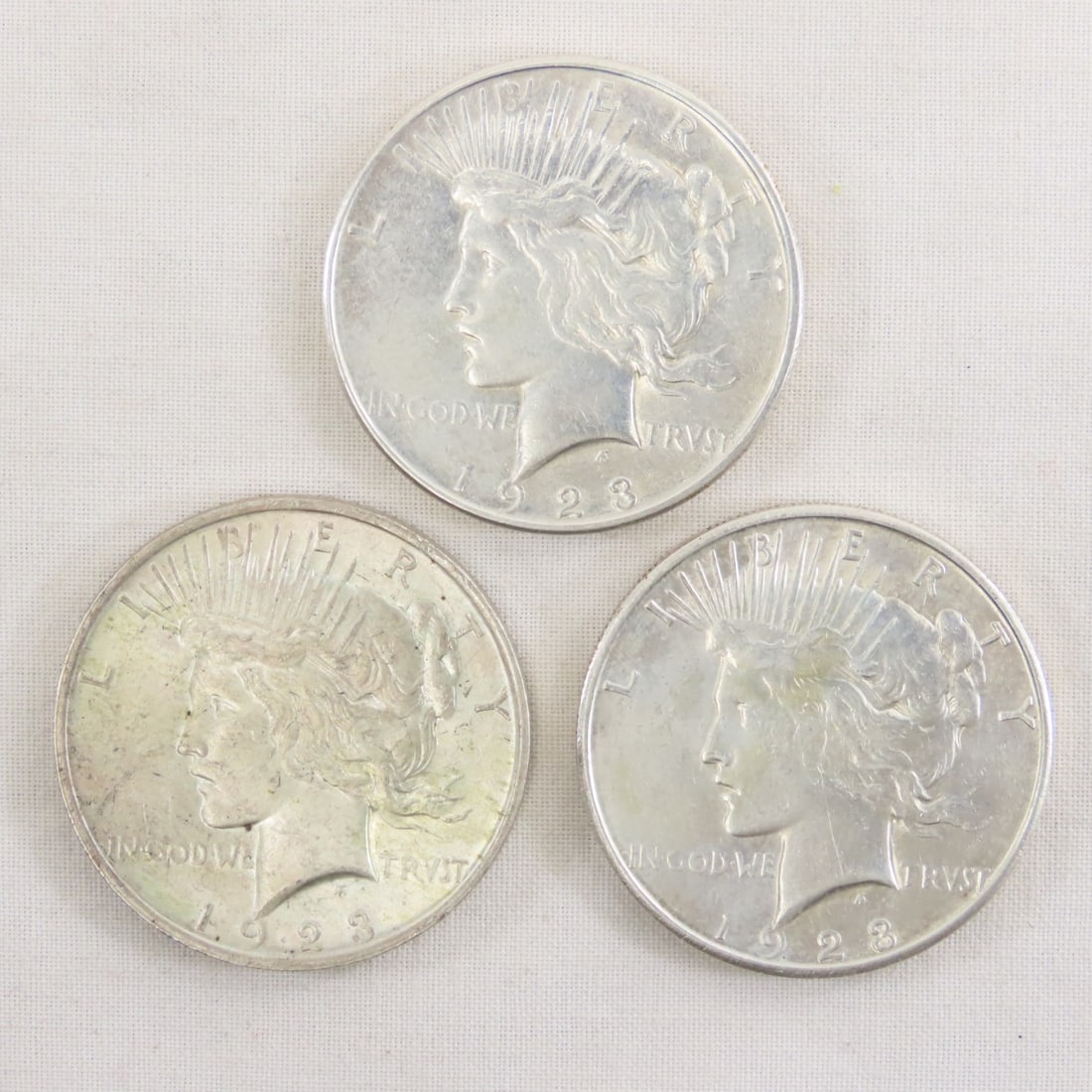 1923 P,D,S Peace Silver Dollars: 1923 P,D,S Peace Silver Dollars - Lot Size 2x2x1" 1 LB All information and photos are intended to be as accurate as possible, but errors are possible. No item may be returned or refused based on this