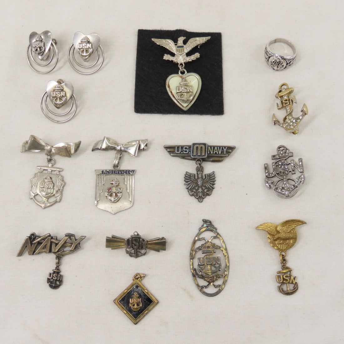 US Navy Sterling Silver Sweetheart Jewelry- 2 OZ: US Navy Sterling Silver Sweetheart Jewelry- 2 OZ - size 4 ring, 3 screw back earrings, 2 pendants and the rest are brooches. LOT SIZE: 3x4x4", 1 LB All information and photos are intended to be as acc