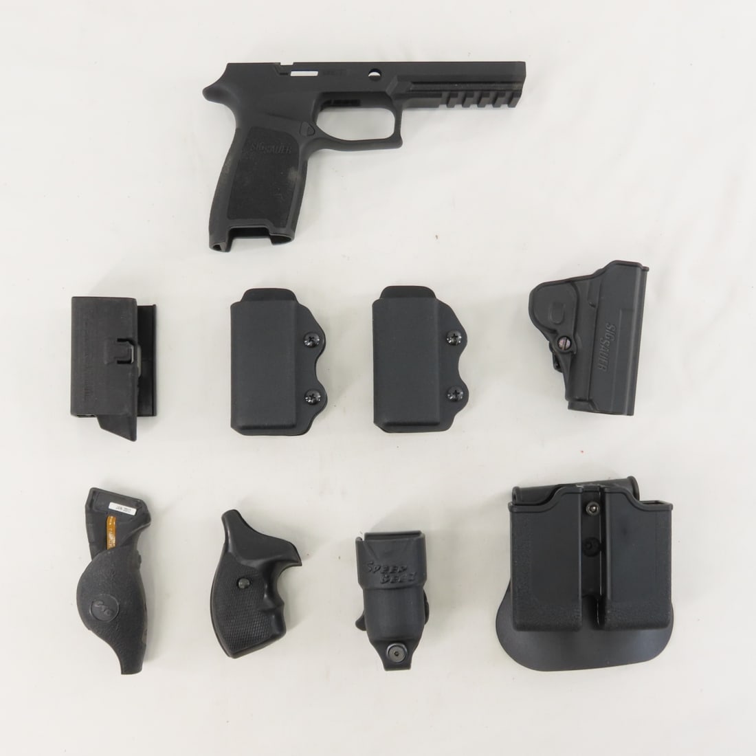 Sig Sauer Handgun Frame, Holsters, accessories: Sig Sauer Handgun Frame, Holsters, accessories - Lot Size 8x8x8" 2 LB All information and photos are intended to be as accurate as possible, but errors are possible. No item may be returned or