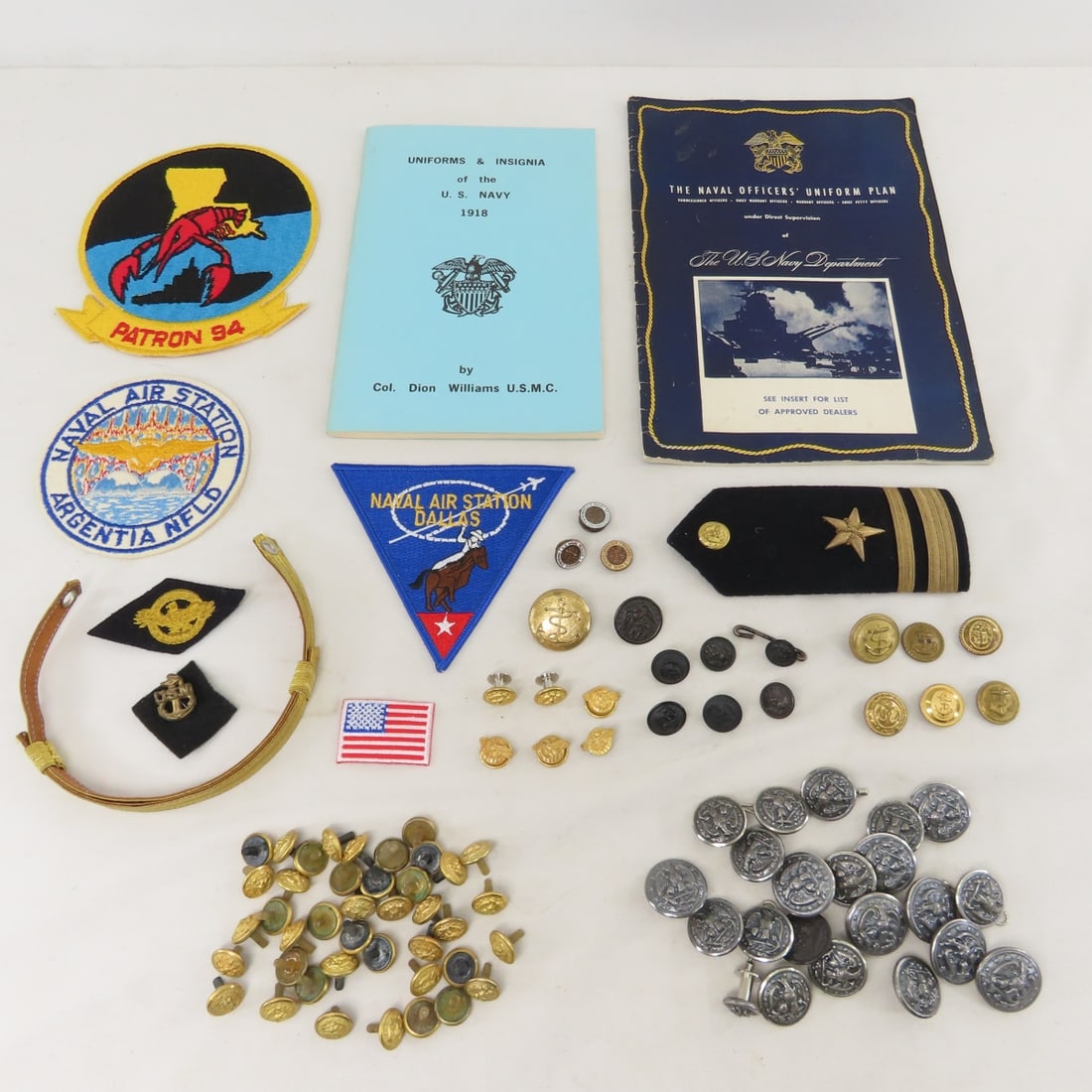 US Navy Buttons, Patches, Uniform Booklets & More: US Navy Buttons, Patches, Uniform Booklets & More - 1 shoulder board, 1 chin strap, honorable discharge pins and more. LOT SIZE: 10x7x3", 2 LBS All information and photos are intended to be as accurat