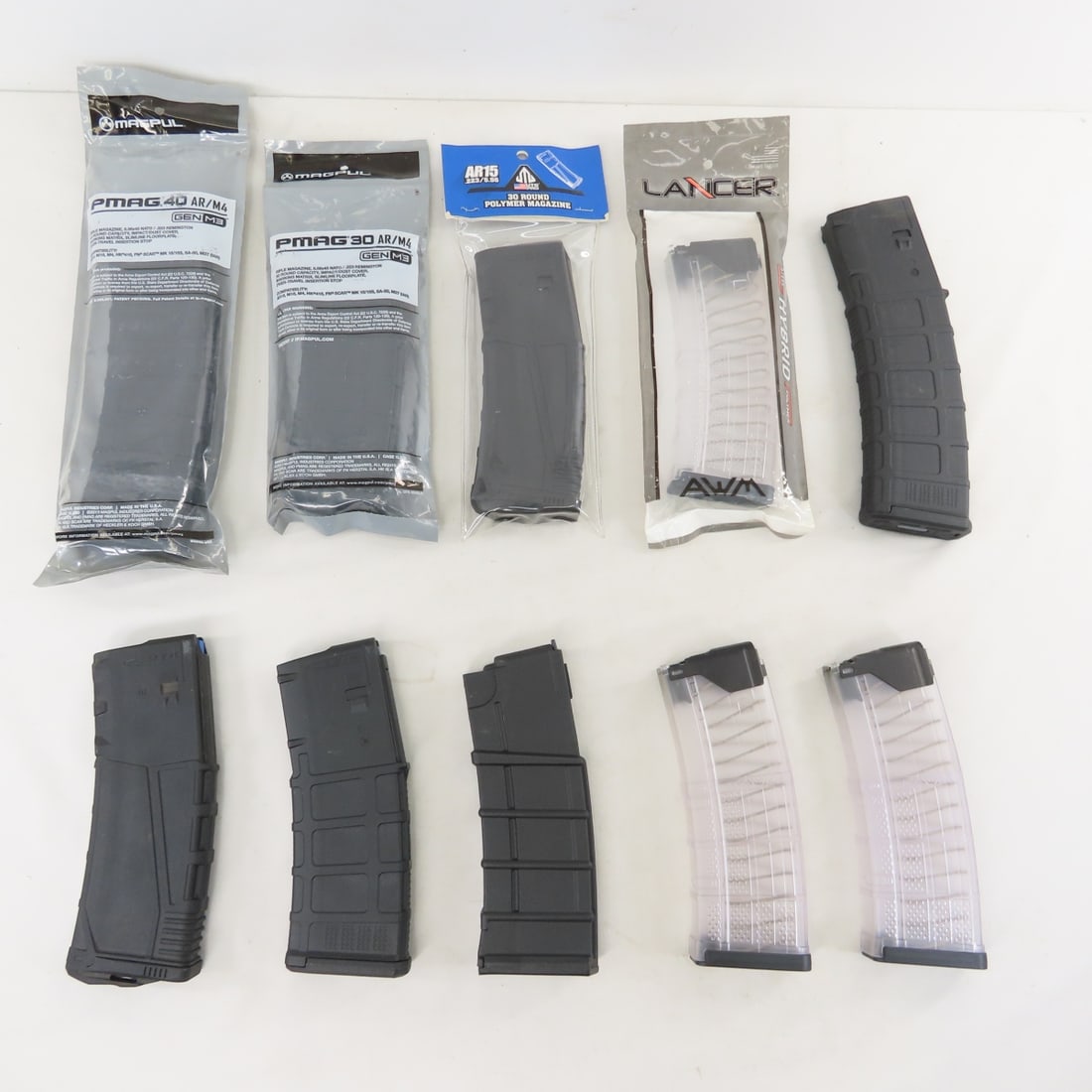 10 Assorted AR/M4 5.56/.223 Plastic Magazines: 10 Assorted AR/M4 5.56/.223 Plastic Magazines - 2 PMAG 40 Gen M3 (1 NIP), 2 PMAG 30 GEN M# (1 NIP), 2 UTG Pro AR5 30 round (1 NIP), 1 ProMag Standard 30 rd, 3 LANCER Hybrid 30 rd (1 NIP). LOT SIZE: 12