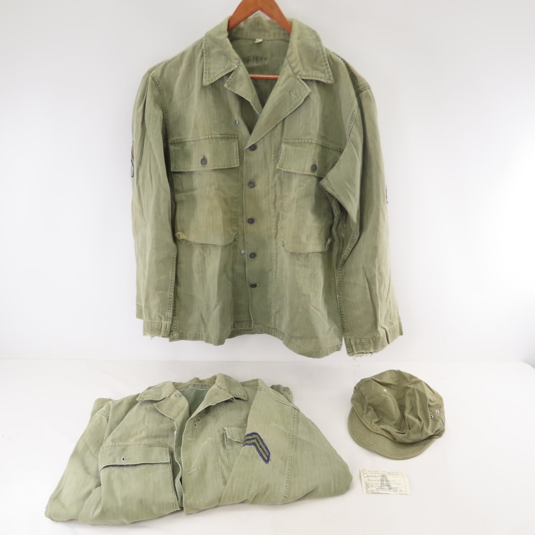 US Army HBT Cap & 2 Jackets w/13 Star Buttons: US Army HBT Cap & 2 Jackets w/13 Star Buttons - with corporal Chevrons, Meal card in pocket from Mar 11- 1955. HBT (HerringBone Twill). Both size 36R with wear throughout especially on cuffs and