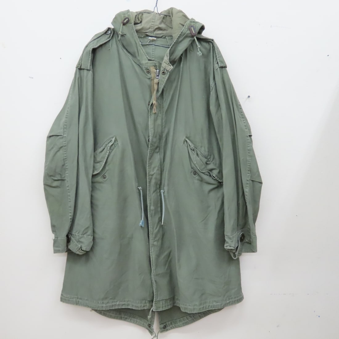 Korean War era “swallow-tail” parka shell w/hood: Korean War era “swallow-tail” parka shell w/hood - Tag is illegible, but looks to be in large to extra-large size. In used veteran condition. Lot Size 12x12x4" 4 LB All information and