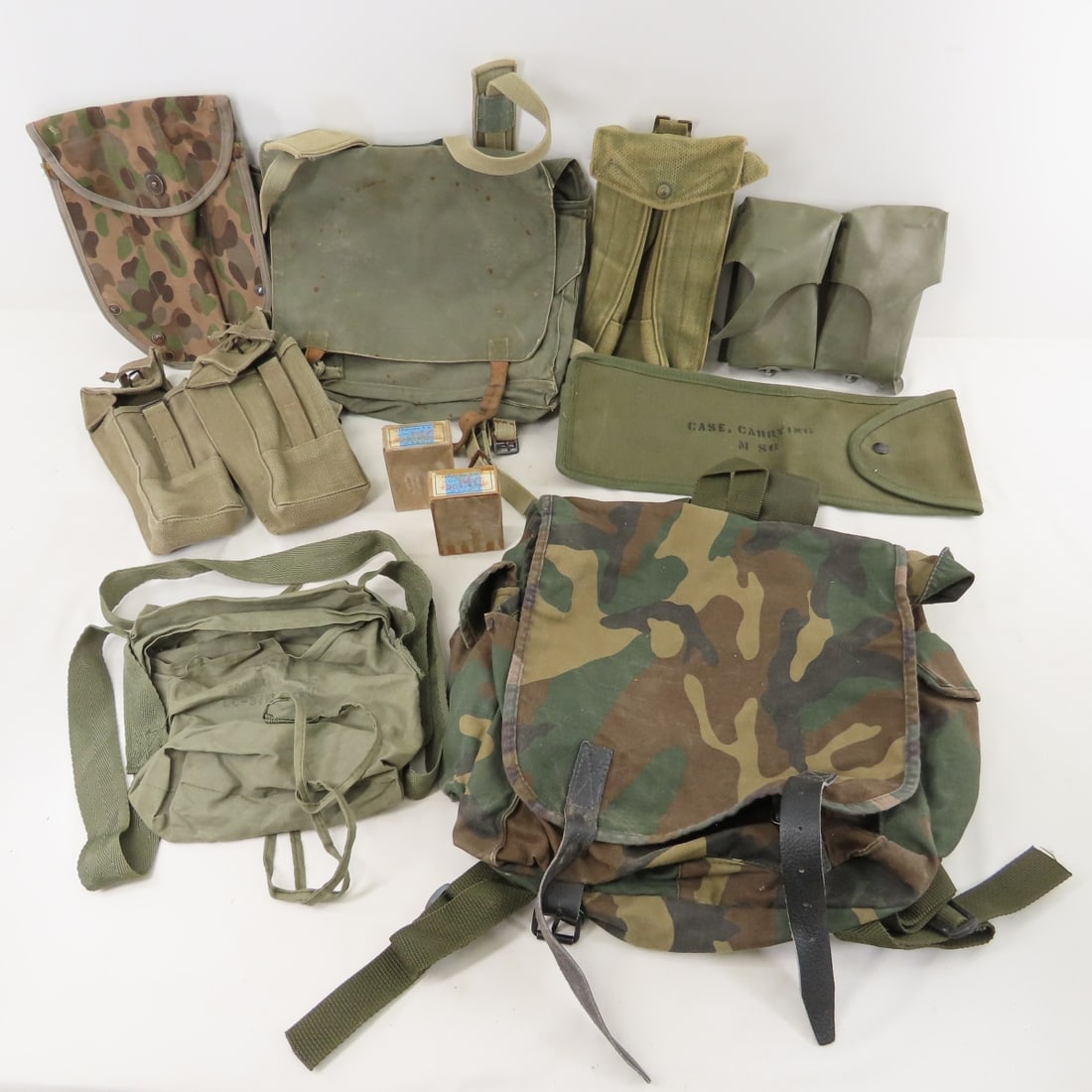 Vintage US & Other Military Bags & Pouches: Vintage US & Other Military Bags & Pouches - British Magazine Pouch, German Ammunition Pouch, Austrian Entrenching Tool Cover, Yugoslavian Carry Bag & Backpack & more. Lot Size: 16 x 13 x 6", 5 lbs Al