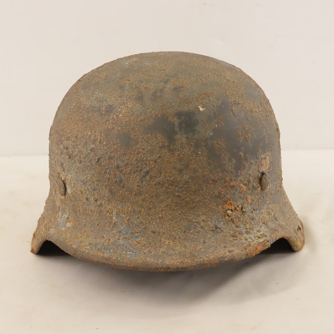 WWII German M42 Steel Combat Helmet: WWII German M42 Steel Combat Helmet - Steel shows corrosion and liner heavily damaged. Stamp is difficult to see but appears to have a '49'. Lot Size: 12 x 9 x 7", 3 lbs All information and photos are