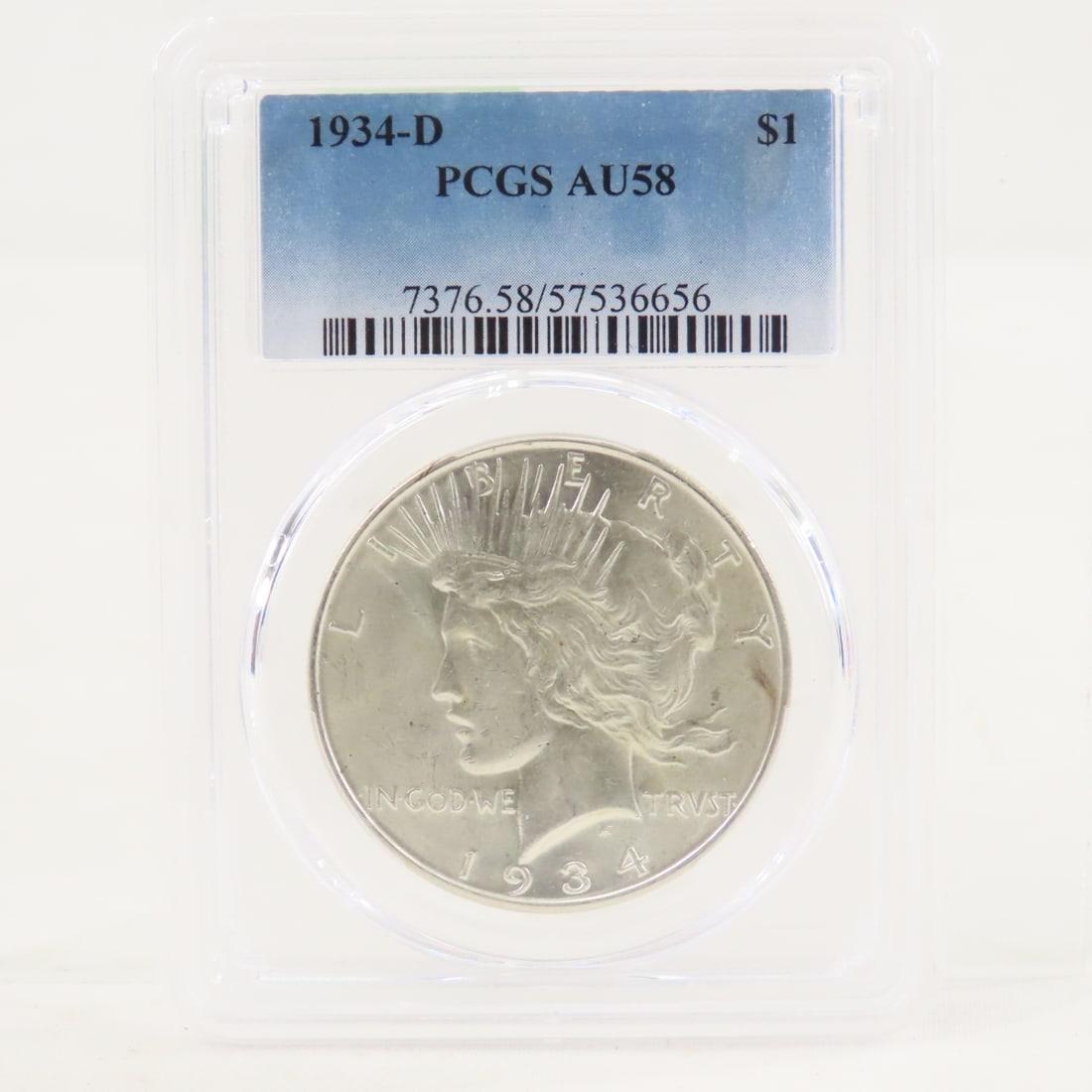 1934 D Peace Silver Dollar PCGS AU58: 1934 D Peace Silver Dollar PCGS AU58 - Lot Size 4x3x1" 1 LB All information and photos are intended to be as accurate as possible, but errors are possible. No item may be returned or refused based on