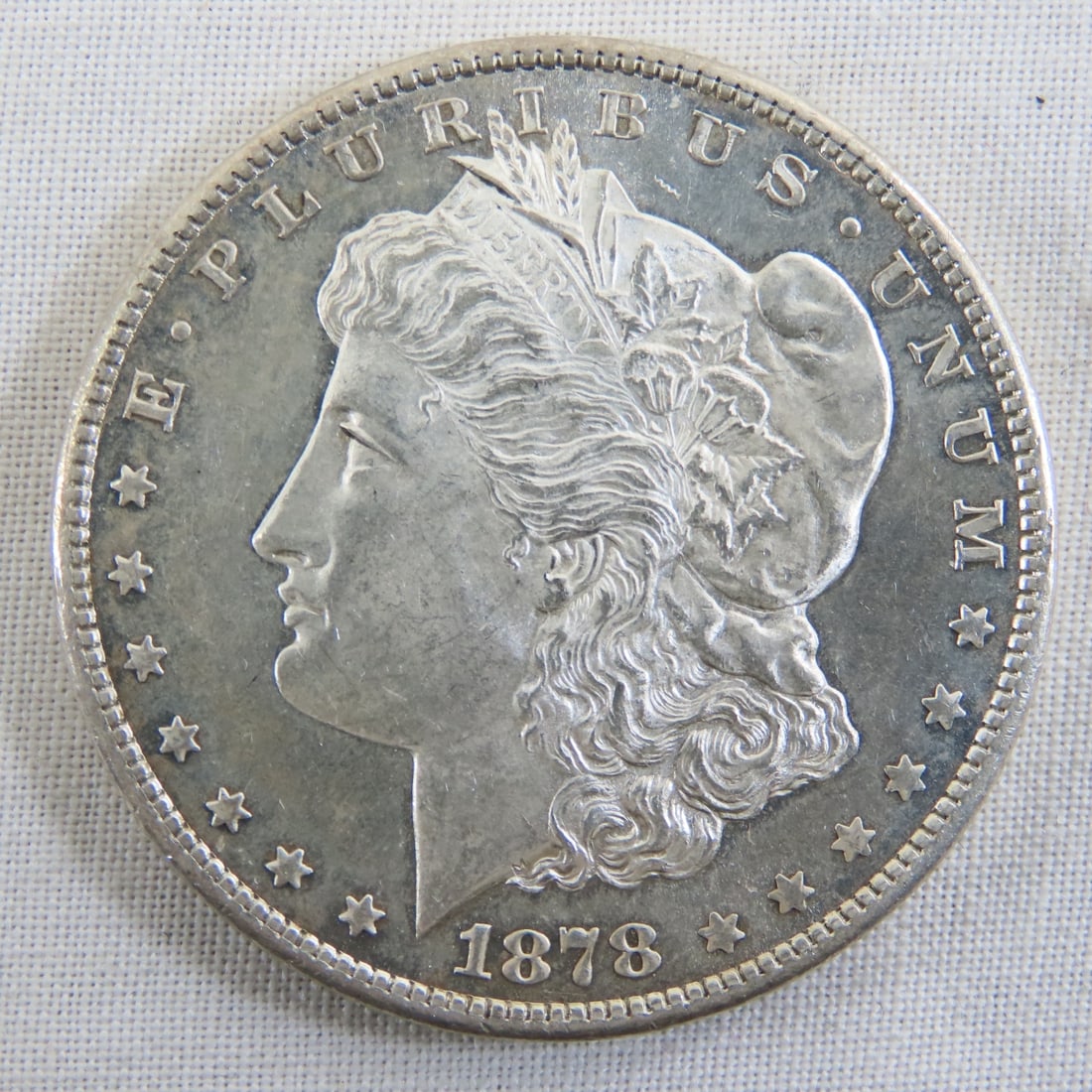 1878 S Morgan Silver Dollar BU: 1878 S Morgan Silver Dollar BU - Lot Size 2x2x2" 1 LB All information and photos are intended to be as accurate as possible, but errors are possible. No item may be returned or refused based on this i