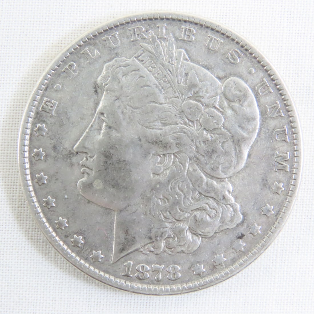 1878 Morgan Silver Dollar: 1878 Morgan Silver Dollar - Lot Size 2x2x1" 1 LB All information and photos are intended to be as accurate as possible, but errors are possible. No item may be returned or refused based on this