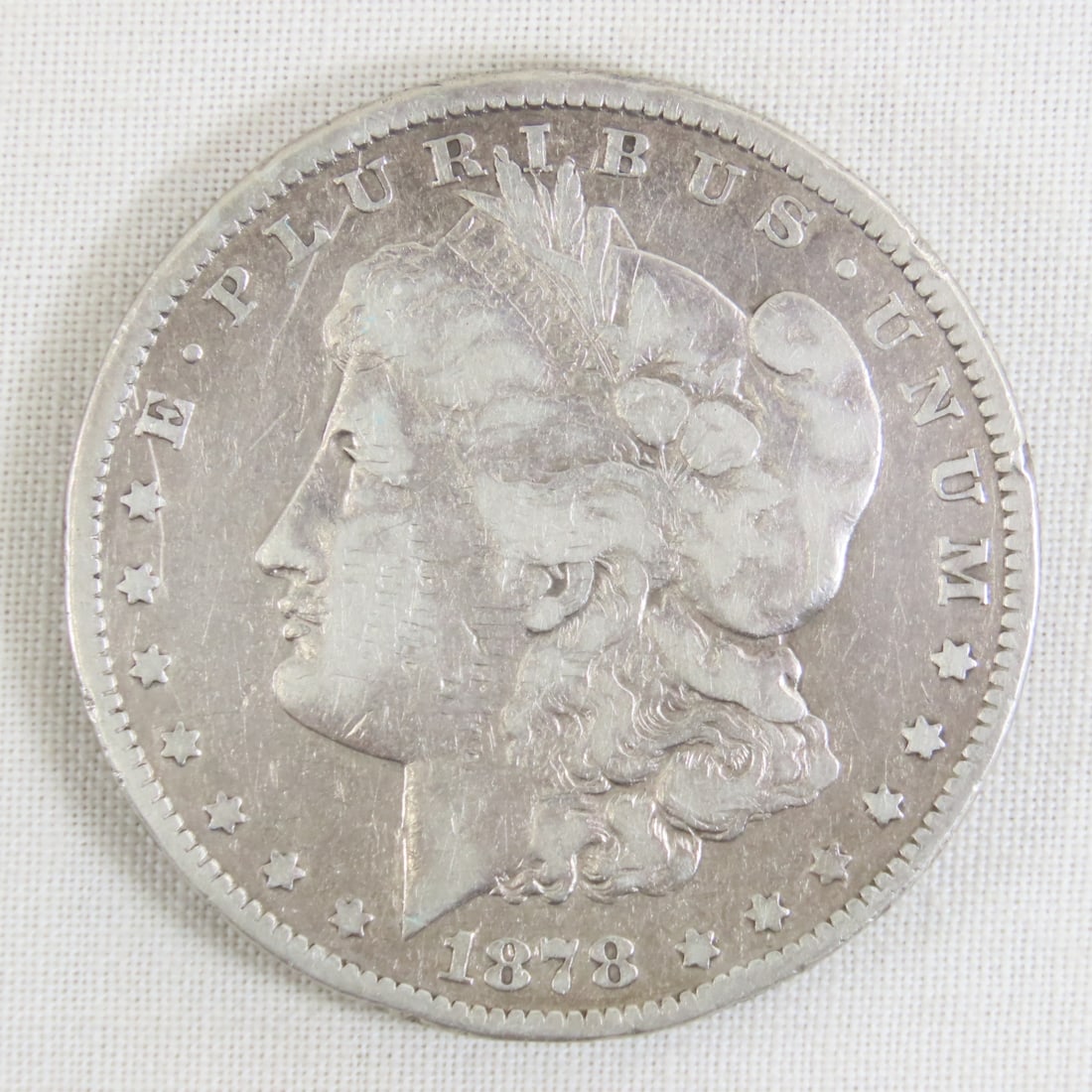 1878 S Morgan Silver Dollar: 1878 S Morgan Silver Dollar - Lot Size 2x2x1" 1 LB All information and photos are intended to be as accurate as possible, but errors are possible. No item may be returned or refused based on this