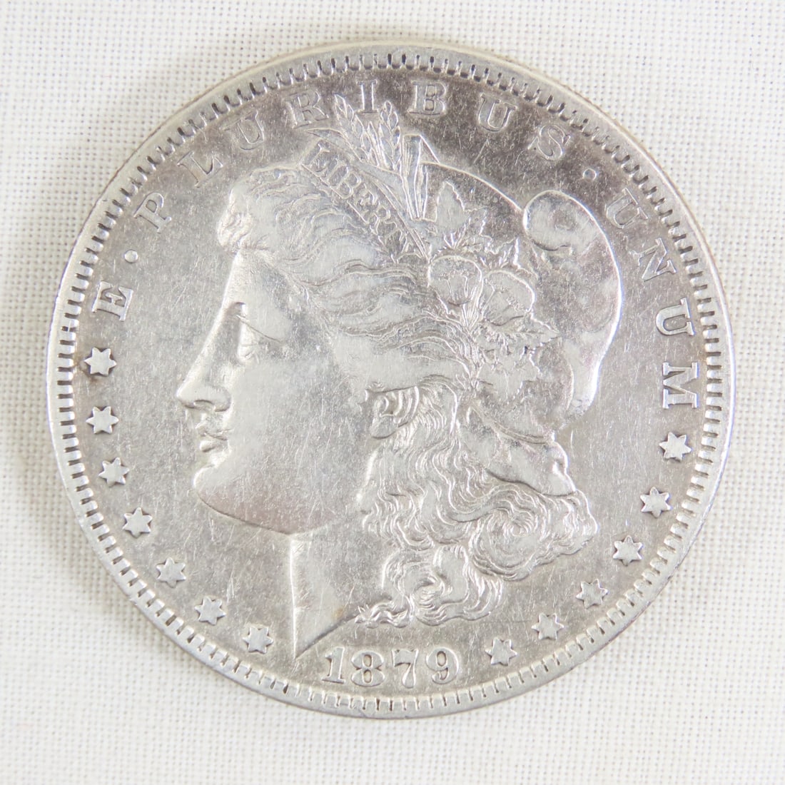 1879 Morgan Silver Dollar: 1879 Morgan Silver Dollar - Lot Size 2x2x1" 1 LB All information and photos are intended to be as accurate as possible, but errors are possible. No item may be returned or refused based on this