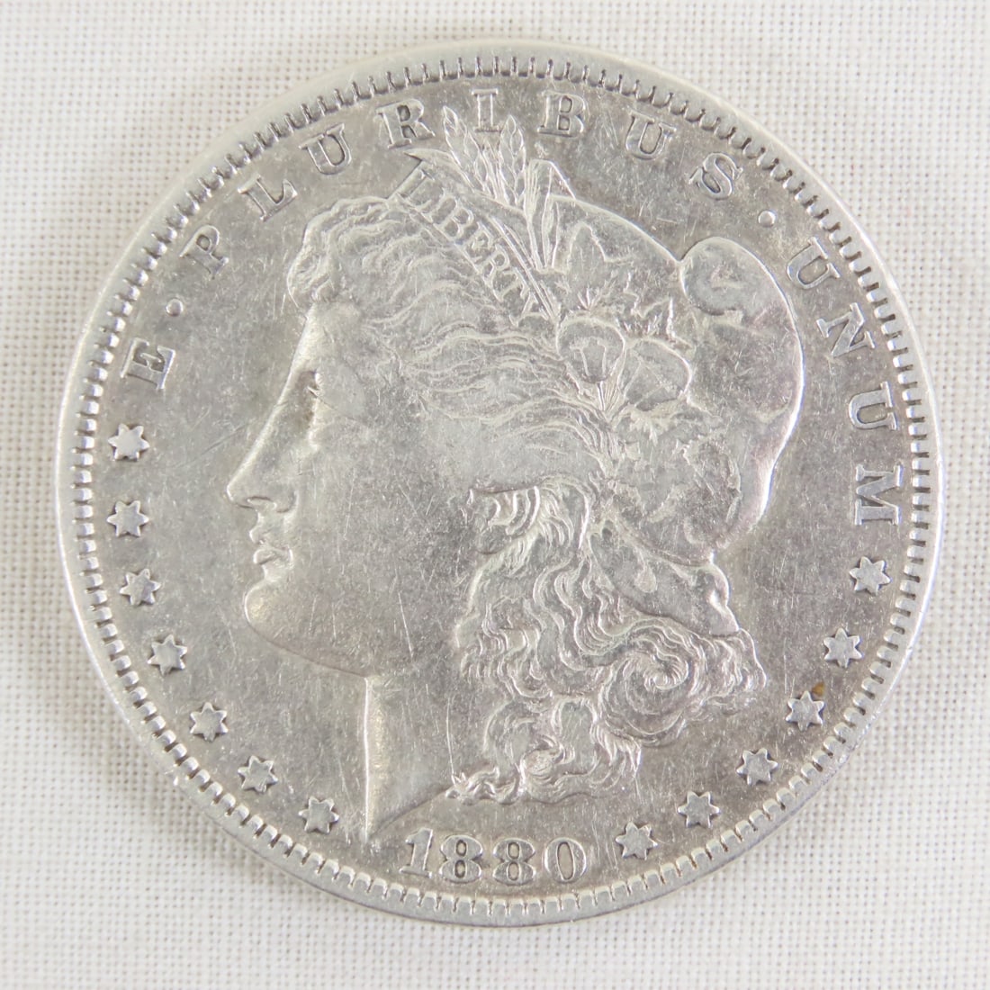 1880 Morgan Silver Dollar: 1880 Morgan Silver Dollar - Lot Size 2x2x1" 1 LB All information and photos are intended to be as accurate as possible, but errors are possible. No item may be returned or refused based on this inform