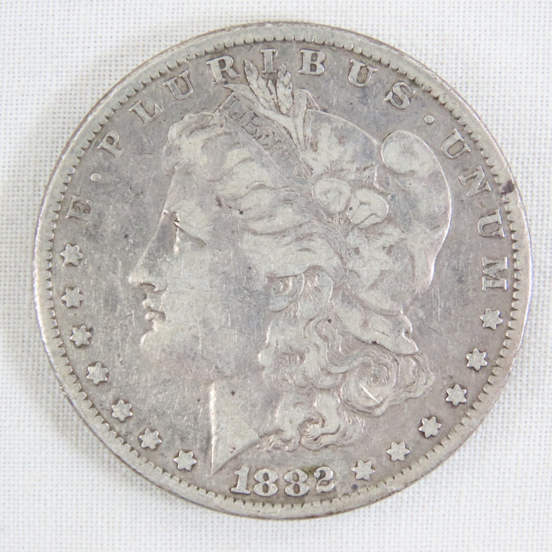 1882 Morgan Silver Dollar: 1882 Morgan Silver Dollar - Lot Size 2x2x1" 1 LB All information and photos are intended to be as accurate as possible, but errors are possible. No item may be returned or refused based on this