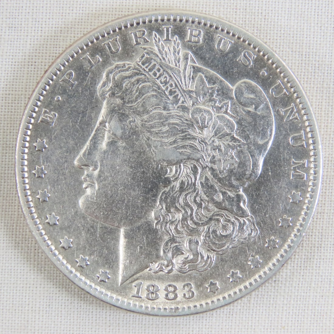 1883 Morgan Silver Dollar: 1883 Morgan Silver Dollar - Lot Size 2x2x1" 1 LB All information and photos are intended to be as accurate as possible, but errors are possible. No item may be returned or refused based on this