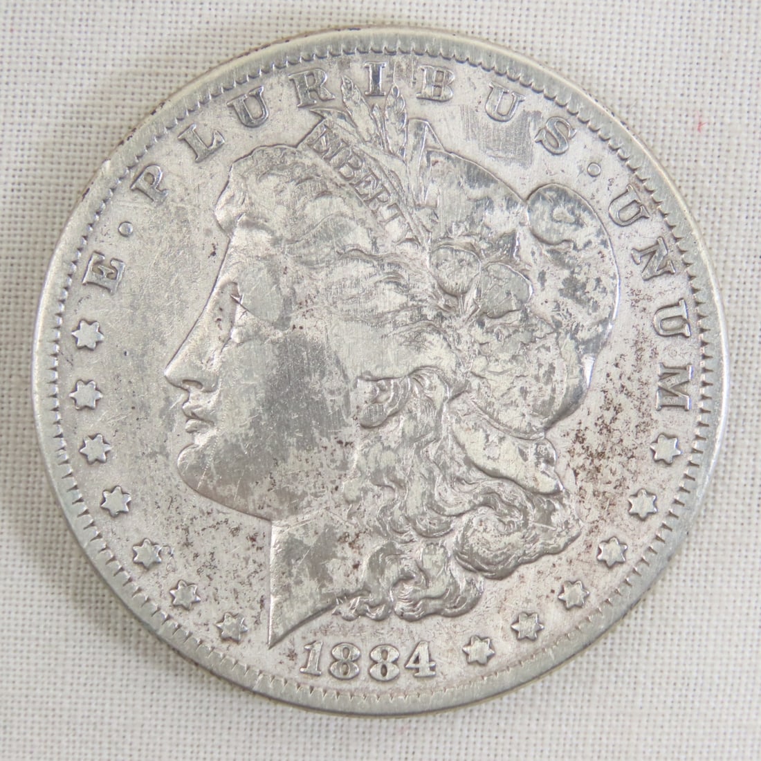 1884 Morgan Silver Dollar: 1884 Morgan Silver Dollar - Lot Size 2x2x1" 1 LB All information and photos are intended to be as accurate as possible, but errors are possible. No item may be returned or refused based on this