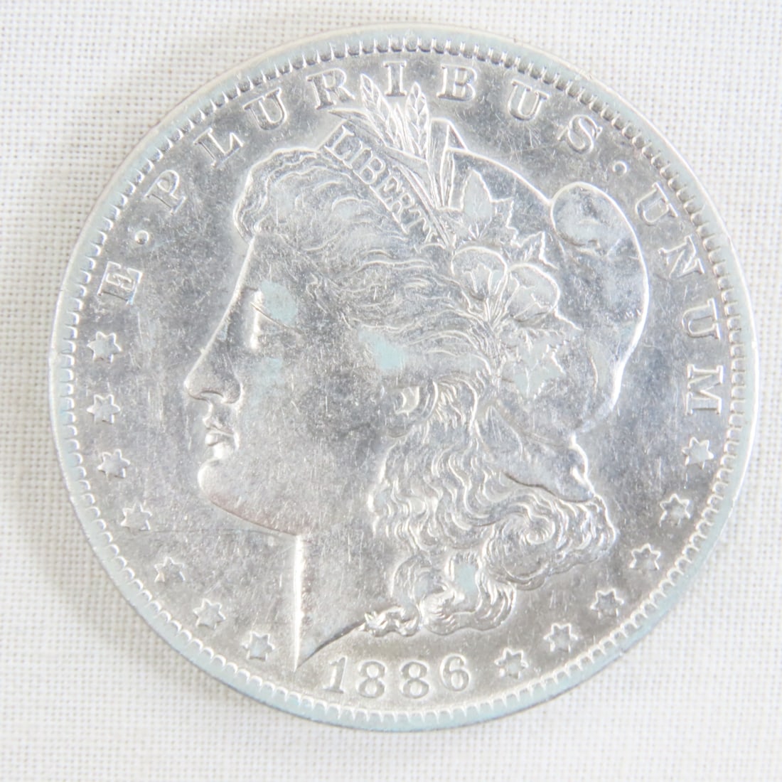 1886 O Morgan Silver Dollar: 1886 O Morgan Silver Dollar - Lot Size 2x2x1" 1 LB All information and photos are intended to be as accurate as possible, but errors are possible. No item may be returned or refused based on this
