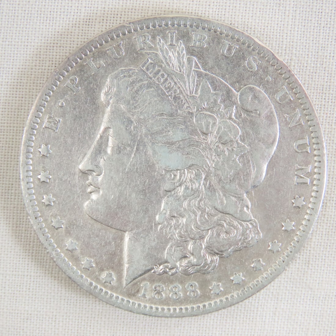 1888 O Morgan Silver Dollar: 1888 O Morgan Silver Dollar - Lot Size 2x2x1" 1 LB All information and photos are intended to be as accurate as possible, but errors are possible. No item may be returned or refused based on this info