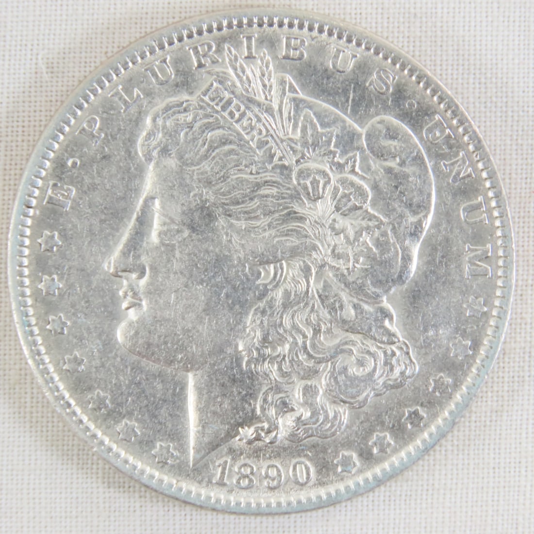 1890 Morgan Silver Dollar: 1890 Morgan Silver Dollar - Lot Size 2x2x1" 1 LB All information and photos are intended to be as accurate as possible, but errors are possible. No item may be returned or refused based on this