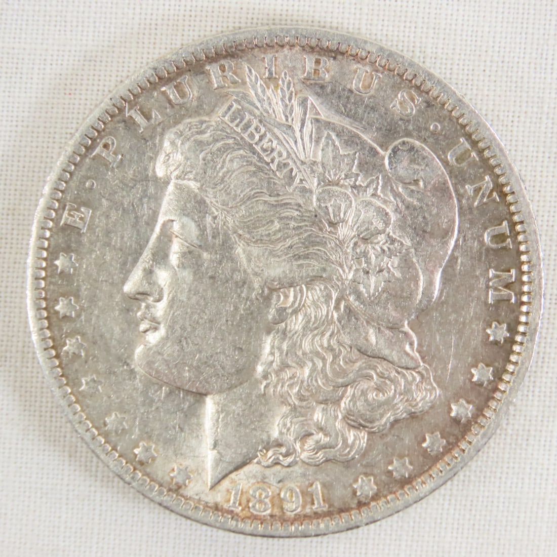 1891 O Morgan Silver Dollar: 1891 O Morgan Silver Dollar - Lot Size 2x2x1" 1 LB All information and photos are intended to be as accurate as possible, but errors are possible. No item may be returned or refused based on this