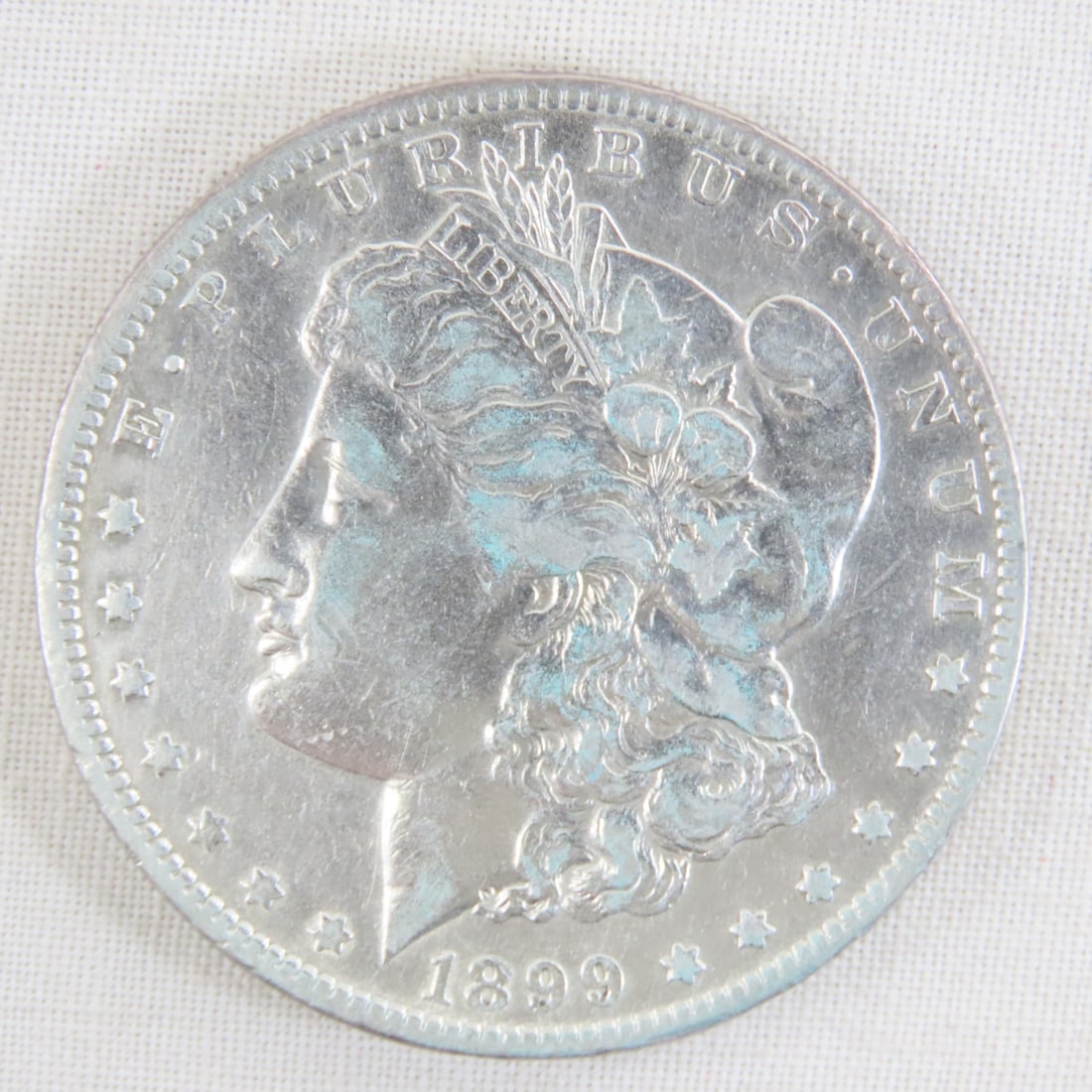 1899 O Morgan Silver Dollar: 1899 O Morgan Silver Dollar - Lot Size 2x2x1" 1 LB All information and photos are intended to be as accurate as possible, but errors are possible. No item may be returned or refused based on this
