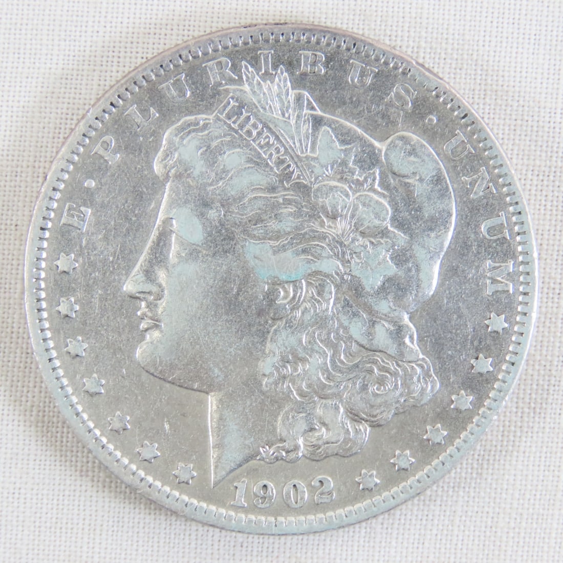 1902 Morgan Silver Dollar: 1902 Morgan Silver Dollar - Lot Size 2x2x1" 1 LB All information and photos are intended to be as accurate as possible, but errors are possible. No item may be returned or refused based on this