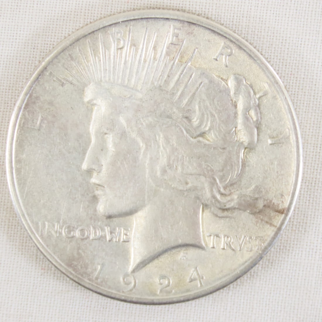1924 Peace Silver Dollar: 1924 Peace Silver Dollar - Lot Size 2x2x1" 1 LB All information and photos are intended to be as accurate as possible, but errors are possible. No item may be returned or refused based on this