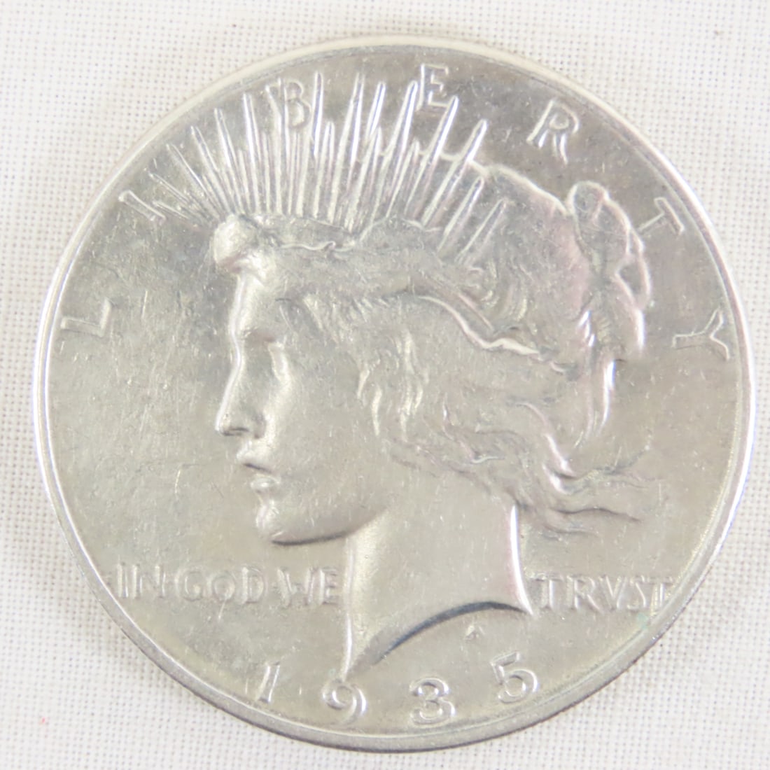 1935 Peace Silver Dollar: 1935 Peace Silver Dollar - Lot Size 2x2x1" 1 LB All information and photos are intended to be as accurate as possible, but errors are possible. No item may be returned or refused based on this informa
