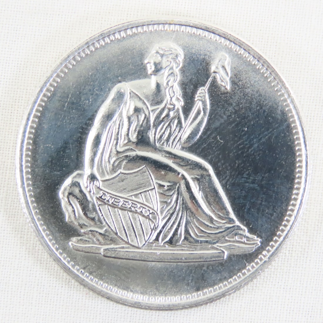 Seated Liberty Style 1ozt .999 Silver Round: Seated Liberty Style 1ozt .999 Silver Round - Lot Size 2x2x1" 1 LB All information and photos are intended to be as accurate as possible, but errors are possible. No item may be returned or refused