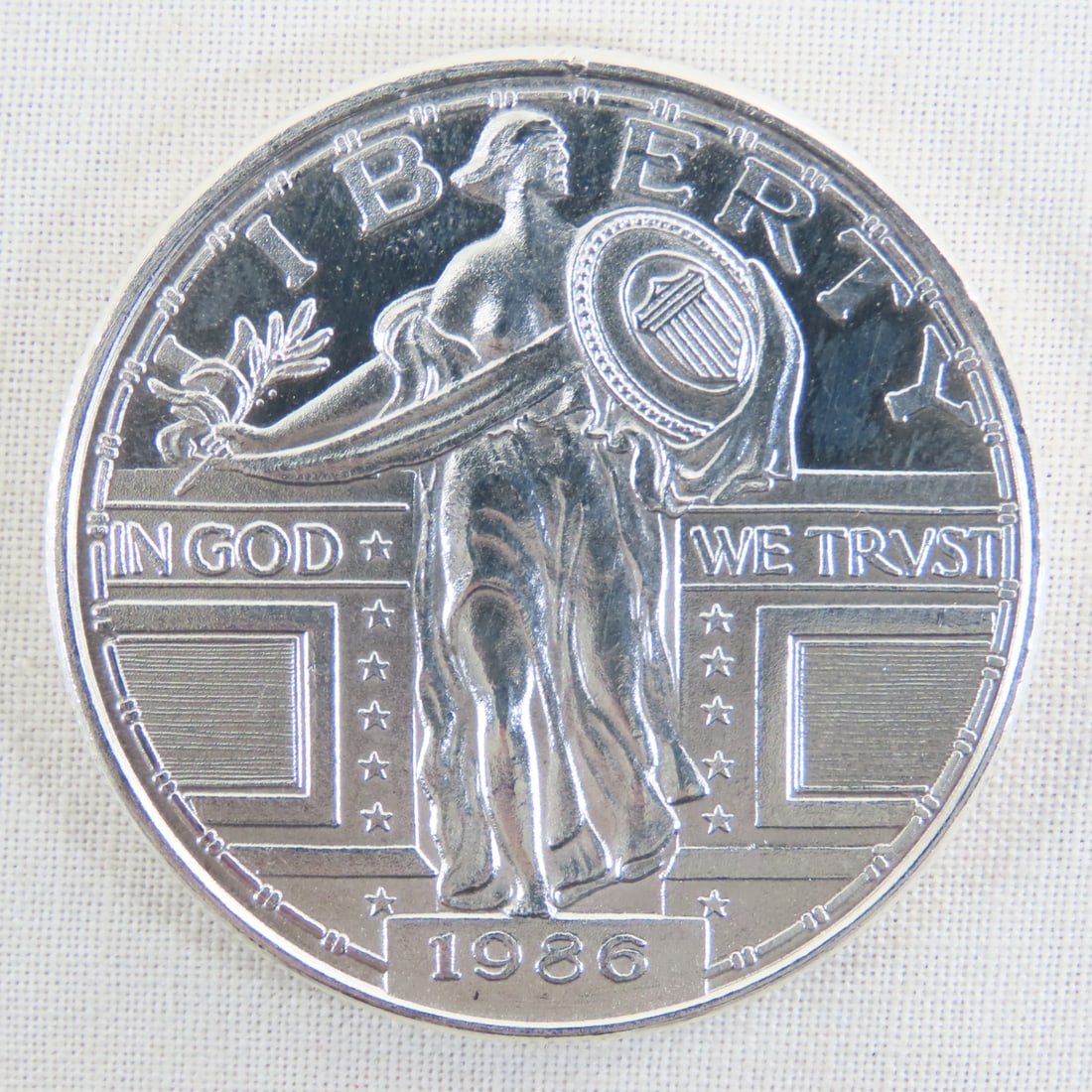 1986 Standing Liberty Style 1ozt .999 Silver Round: 1986 Standing Liberty Style 1ozt .999 Silver Round - Lot Size 2x2x1" 1 LB All information and photos are intended to be as accurate as possible, but errors are possible. No item may be returned or
