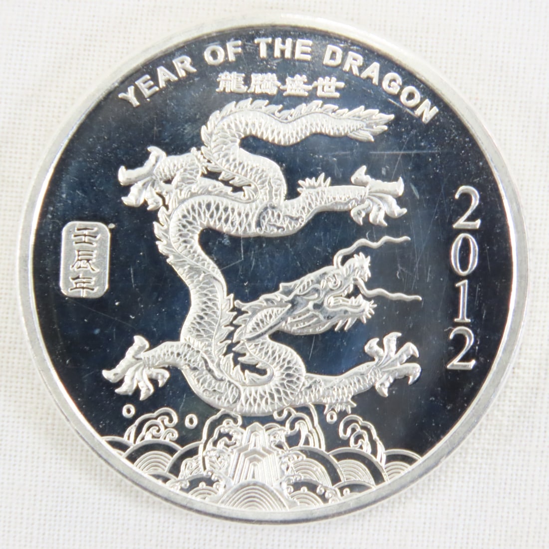 2012 Year of the Dragon 1ozt .999 Silver Round: 2012 Year of the Dragon 1ozt .999 Silver Round - Lot Size 2x2x1" 1 LB All information and photos are intended to be as accurate as possible, but errors are possible. No item may be returned or