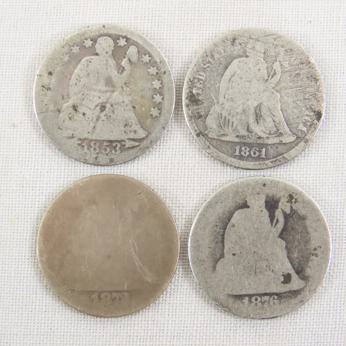 4 Seated Liberty Dimes 1853, 1861, 1872, 1876: 4 Seated Liberty Dimes 1853, 1861, 1872, 1876 - Lot Size 2x2x1" 1 LB All information and photos are intended to be as accurate as possible, but errors are possible. No item may be returned or refused